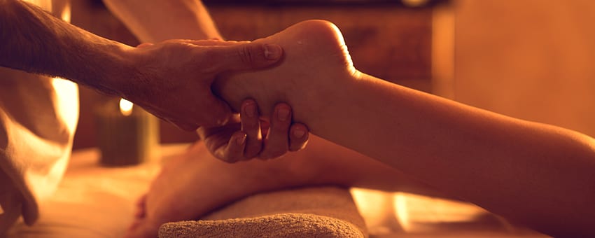 massaging womans foot